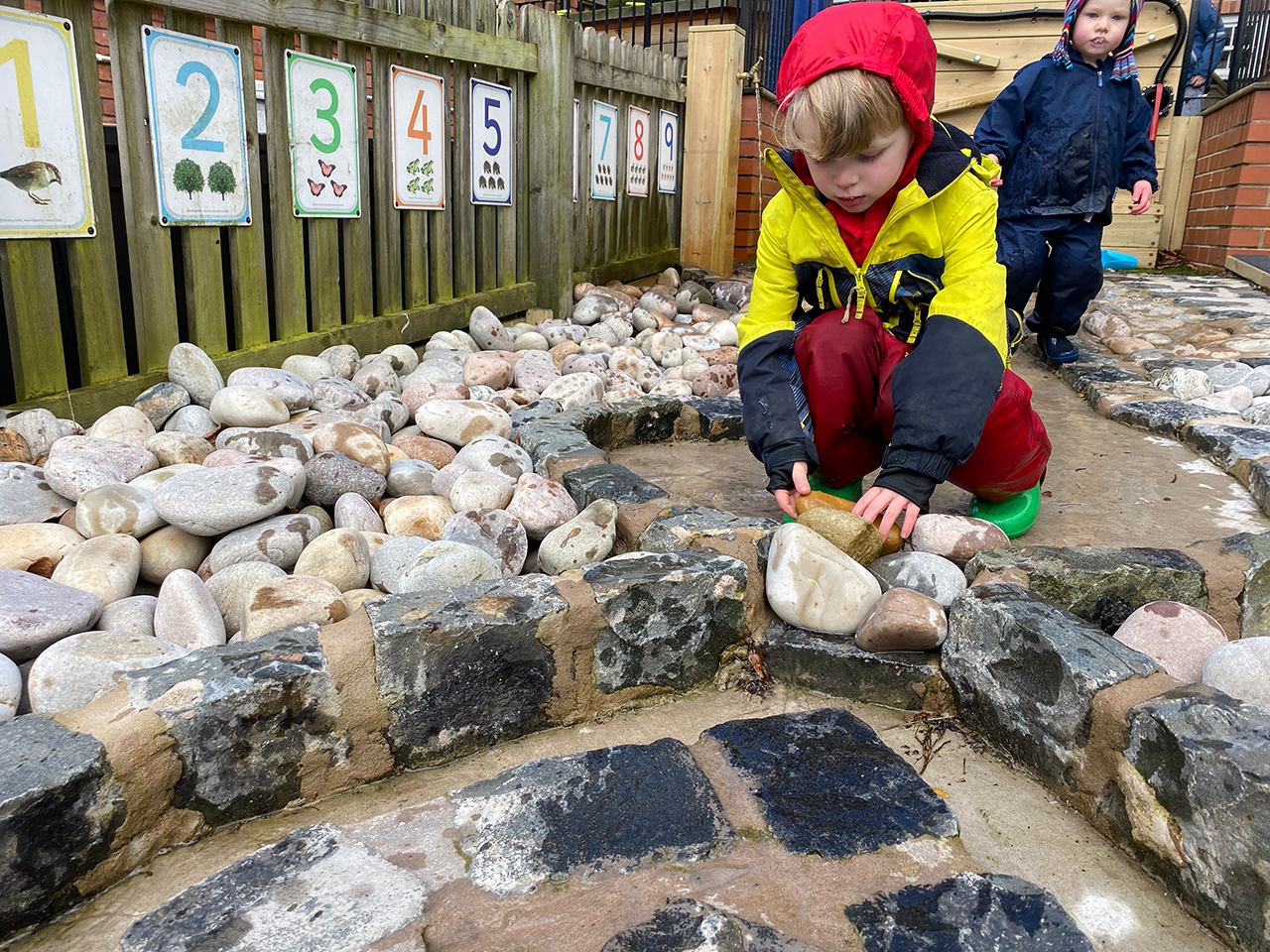 A child enjoying an outside space at Castle Preschool